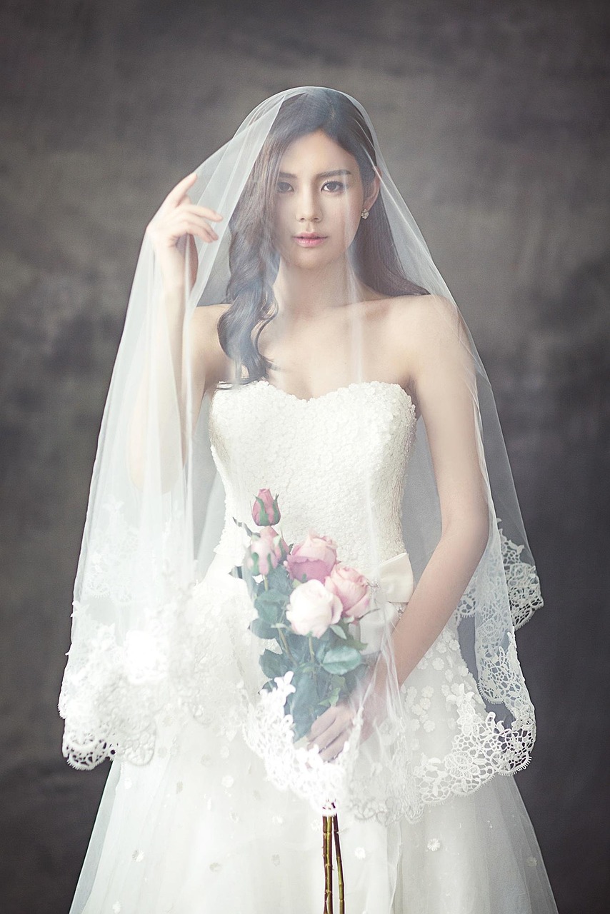 Glastonbury wedding bride holding bouquet by Evergreen Events